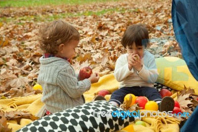 Children Play In The Park And Eating Apple Stock Photo