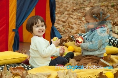 Children Play In The Park And Eating Apple Stock Photo