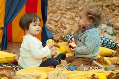 Children Play In The Park And Eating Apple Stock Photo