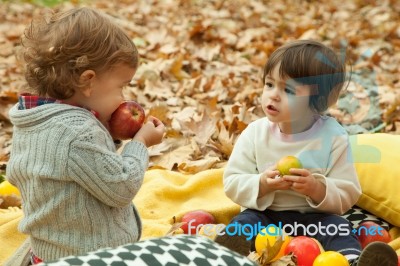 Children Play In The Park And Eating Apple Stock Photo