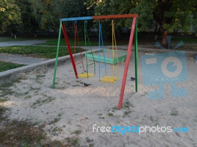 Children Playground, Swing Near The House  Stock Photo