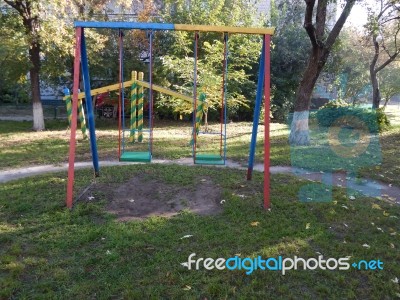 Children Playground, Swing Near The House  Stock Photo