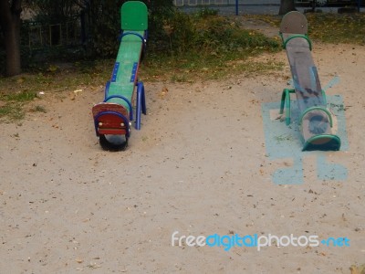 Children Playground, Swing Near The House  Stock Photo