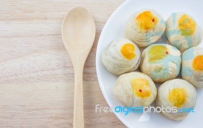 Chinese Pastry Mung Bean Or Mooncake With Egg Yolk On Dish And Wooden Table Spoon Stock Photo