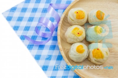 Chinese Pastry Mung Bean Or Mooncake With Egg Yolk On Wooden Dish And Spoon Striped Cloth Ribbon Stock Photo