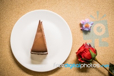 Chocolate Cake On Dish With Flower Stock Photo