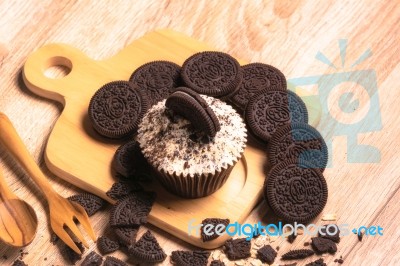 Chocolate Cupcake And Cookies Are On Wooden Plate Stock Photo