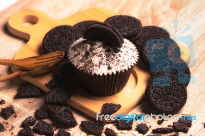 Chocolate Cupcake And Cookies Are On Wooden Plate Stock Photo