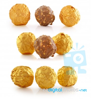 Chocolate  Wrapped In Golden Foil Isolated On White Stock Photo