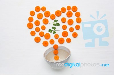 Chopped Carrot Slices Heart Shape And Parsley Leaves With Bowl Stock Photo