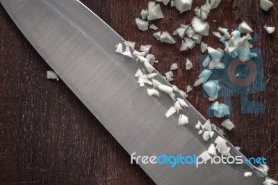 Chopped Onion With Knife On The Wooden Board Top View Stock Photo