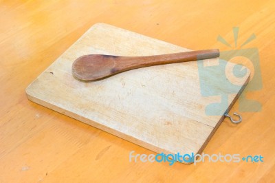 Chopping Block And Wood Spoon On The Table Stock Photo