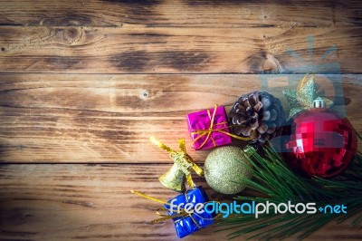 Christmas Background With Christmas Gift,red Balls, Pine Cones On Wooden Background. Christmas Vintage Style Stock Photo