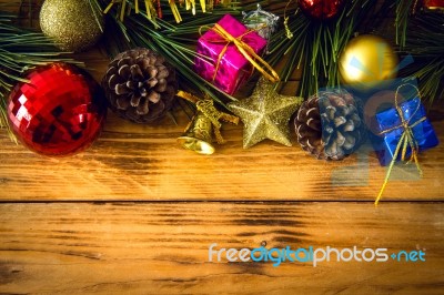 Christmas Background With Christmas Gift,red Balls, Pine Cones On Wooden Background. Christmas Vintage Style Stock Photo