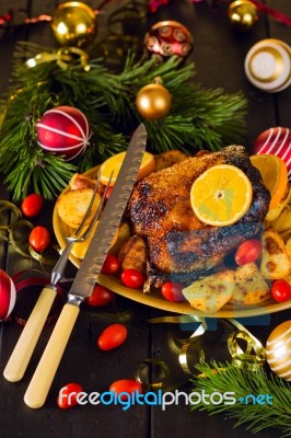 Christmas Baked Duck Served With Potatoes, Orange And Tomatoes Stock Photo