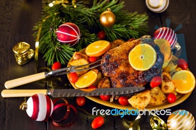 Christmas Baked Duck Served With Potatoes, Orange And Tomatoes Stock Photo