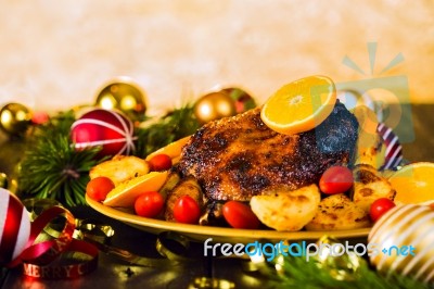 Christmas Baked Duck Served With Potatoes, Orange And Tomatoes Stock Photo