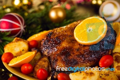 Christmas Baked Duck Served With Potatoes, Orange And Tomatoes Stock Photo