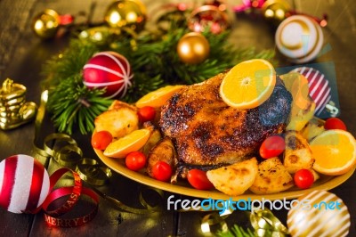 Christmas Baked Duck Served With Potatoes, Orange And Tomatoes Stock Photo