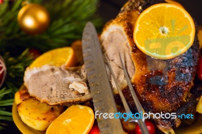 Christmas Baked Duck Served With Potatoes, Orange And Tomatoes Stock Photo