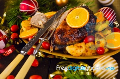 Christmas Baked Duck Served With Potatoes, Orange And Tomatoes Stock Photo