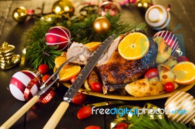 Christmas Baked Duck Served With Potatoes, Orange And Tomatoes Stock Photo