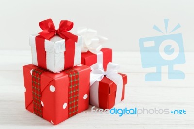 Christmas Gift Boxes On White Wood Table Stock Photo