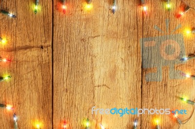 Christmas Light Decorations On Wood Texture Stock Photo