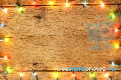 Christmas Light Decorations On Wood Texture Stock Photo