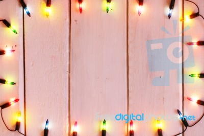 Christmas Light Decorations On Wood Texture Stock Photo