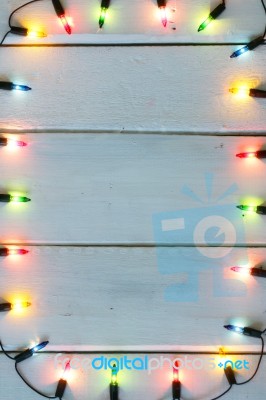 Christmas Light Decorations On Wood Texture Stock Photo