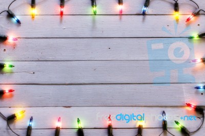 Christmas Light Decorations On Wood Texture Stock Photo