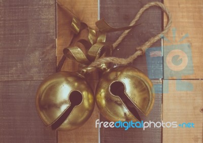 Christmas Sleigh Bells On Wooden Background Stock Photo