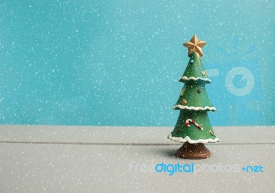 Christmas Tree On Wooden Background With Snow Stock Photo