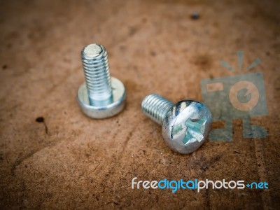 Chrome Nut Wood Background Stock Photo