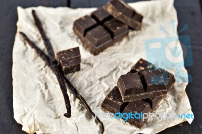 Chunks Of Dark Chocolate Bar And Vanilla Beans Stock Photo