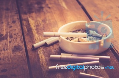 Cigarette With Ashtray On Wood Table Stock Photo