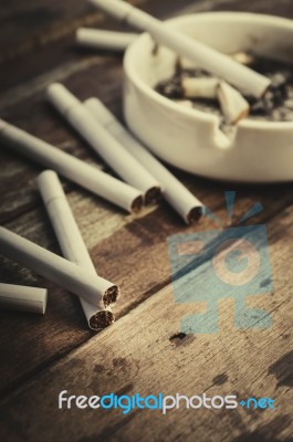 Cigarette With Ashtray On Wood Table Stock Photo