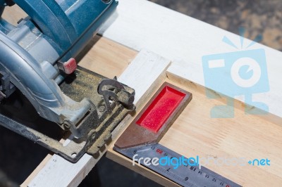 Circular Saw Cutting Wood And Iron Ruler Stock Photo