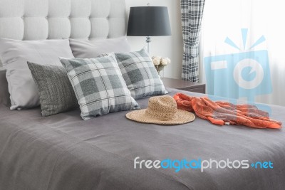 Classic Bed With Pillows, Hat, Cloth And Black Lamp Stock Photo