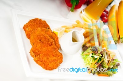 Classic Milanese Veal Cutlets And Vegetables Stock Photo