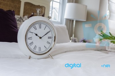 Classic White Alarm Clock Style In Classic Bedroom Stock Photo