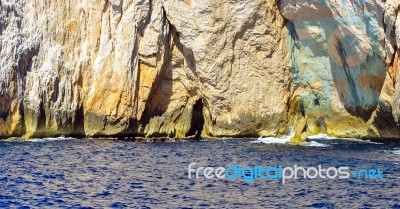 Clear Blue Water Sea With Rocky Coastline Stock Photo