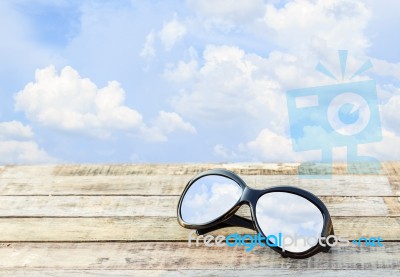 Clear Sky In Eyeglasses On The Wooden Background Stock Photo