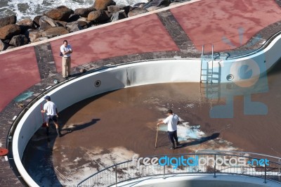 Clearing The Pool Of Silt After The Tropical Storm In Funchal Stock Photo