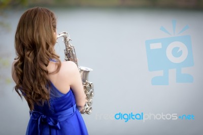 Close Up Beautiful Woman Wear Blue Evening Dress Sound Saxophone… Stock Photo