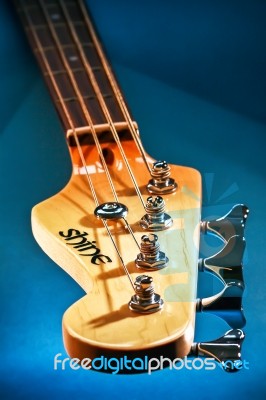 Close-up Electric Bass Guitar Head And Tuning Pegs Stock Photo