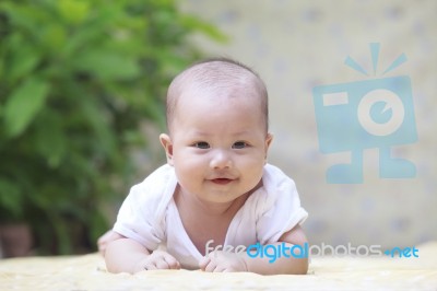 Close Up Face Of Smiling Baby Lying On Soft Bed At Home Terace U… Stock Photo