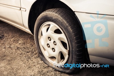 Close Up Flat Tire And Old Car On The Road Waiting For Repair Stock Photo