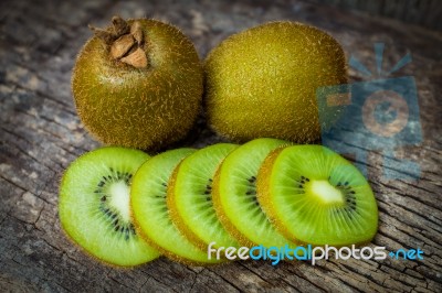 Close Up Fresh Kiwi Fruit On Old Wood Background Stock Photo